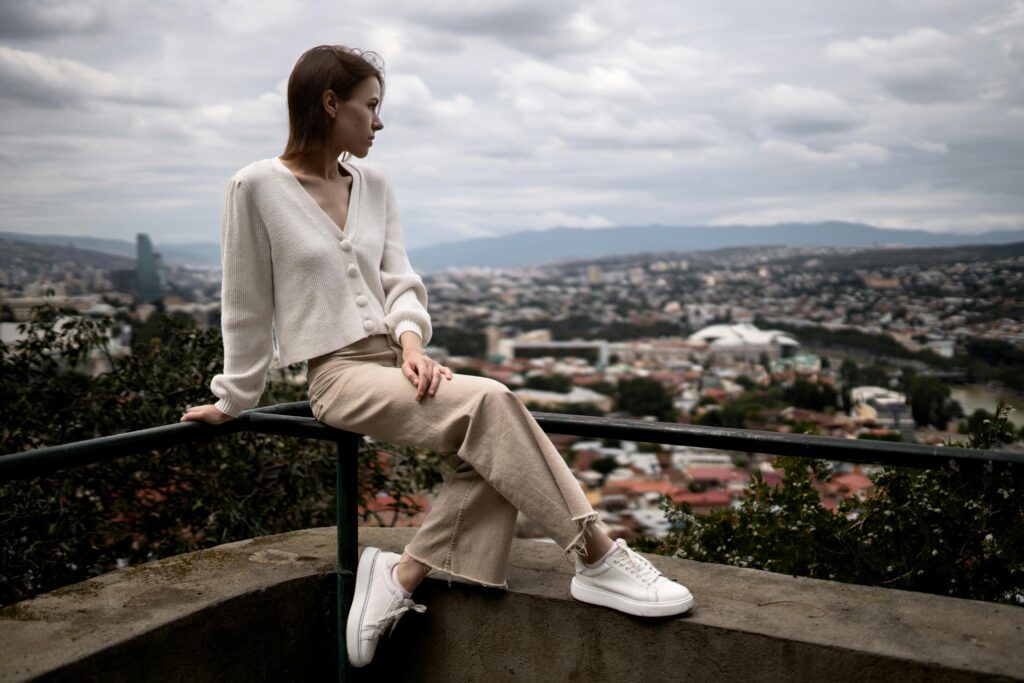 Woman wearing fashionable white leather sneakers