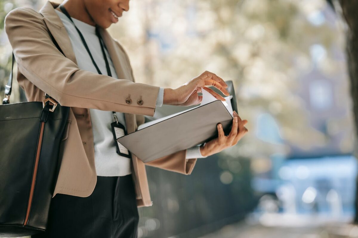 Woman wearing a casual blazer looking through her notes