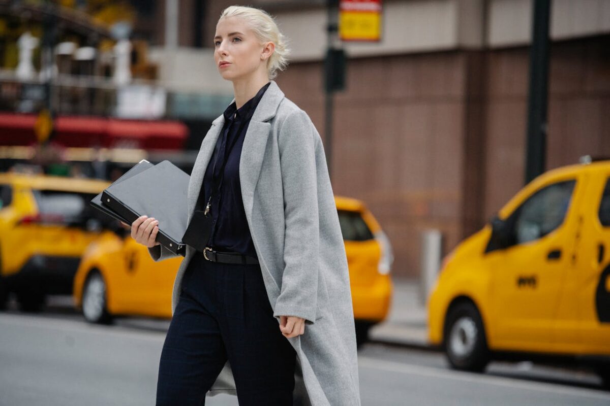 Woman in business casual attire crossing the street