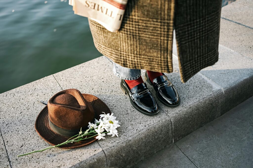 woman wearing fashionable black leather loafers